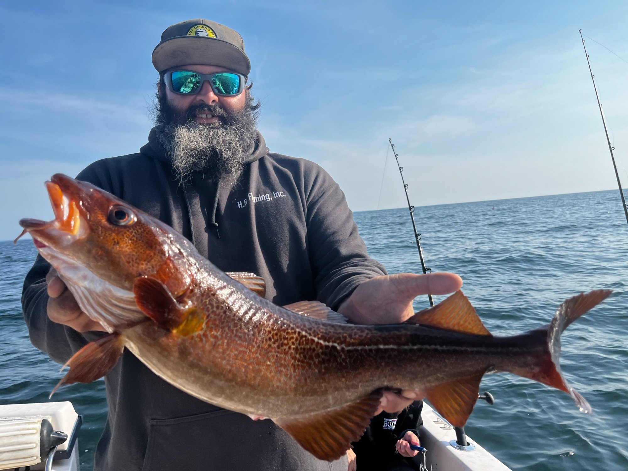 Angler with a large cod on F/V Bad Cast